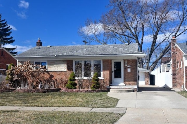 17518 Koester St, Riverview, MI 48193 - view of front of home featuring driveway, a front lawn, brick siding, and a chimney