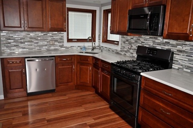 17518 Koester St, Riverview, MI 48193 - kitchen featuring black gas range oven, stainless steel dishwasher, a sink, light countertops, and backsplash
