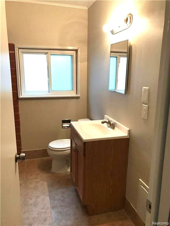8404 Westminster Ave, Warren, MI 48089 - bathroom with toilet, healthy amount of natural light, vanity, and baseboards
