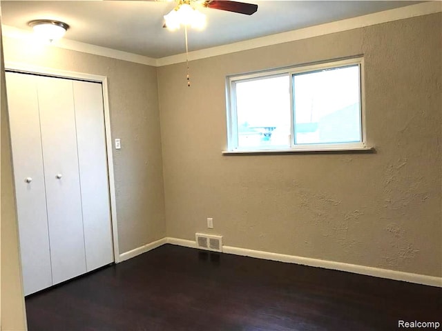 8404 Westminster Ave, Warren, MI 48089 - unfurnished bedroom featuring dark wood-type flooring, a closet, baseboards, and a textured wall