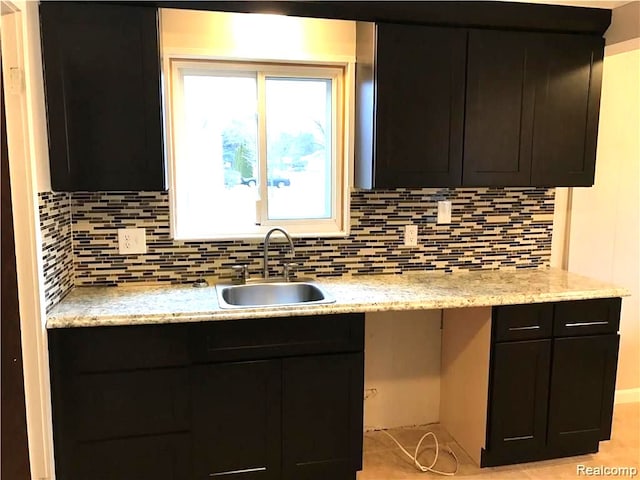 8404 Westminster Ave, Warren, MI 48089 - kitchen with a sink, decorative backsplash, and light stone counters