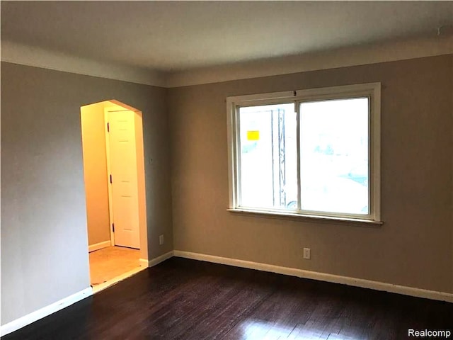 8404 Westminster Ave, Warren, MI 48089 - unfurnished room with dark wood-type flooring, baseboards, and arched walkways
