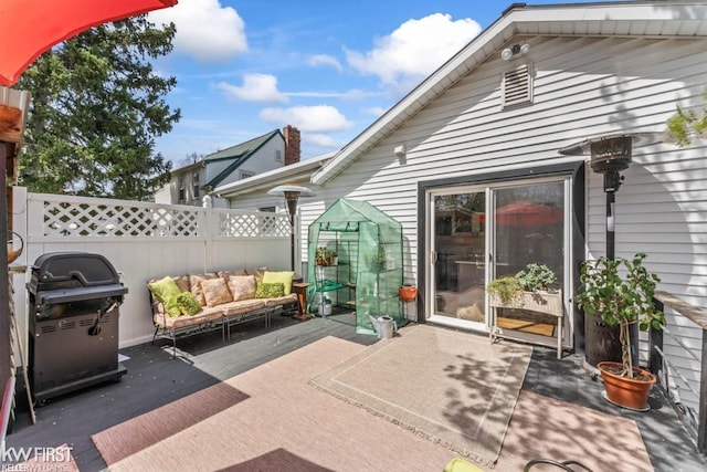 view of patio / terrace featuring fence, an outdoor hangout area, and a grill