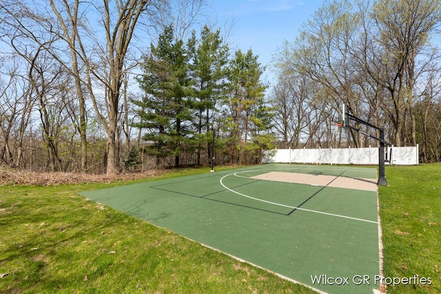 view of sport court with a yard, community basketball court, and fence