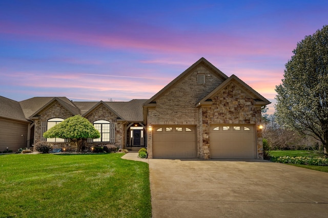 french provincial home featuring a garage, driveway, stone siding, and a front lawn