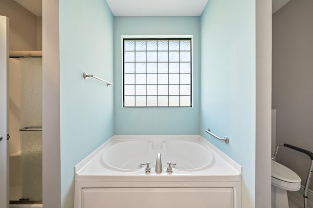 full bathroom featuring a stall shower, toilet, and a bath