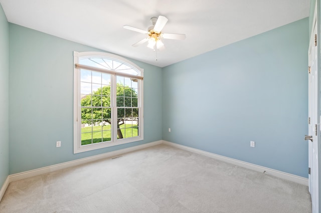 unfurnished room with carpet flooring, baseboards, and ceiling fan