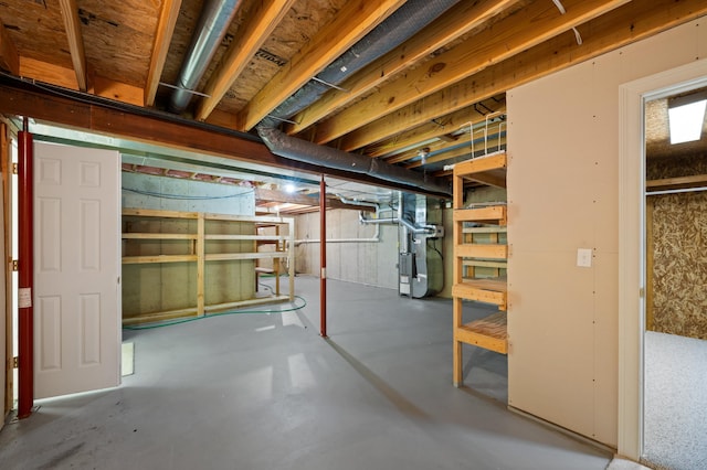 unfinished below grade area featuring heating unit