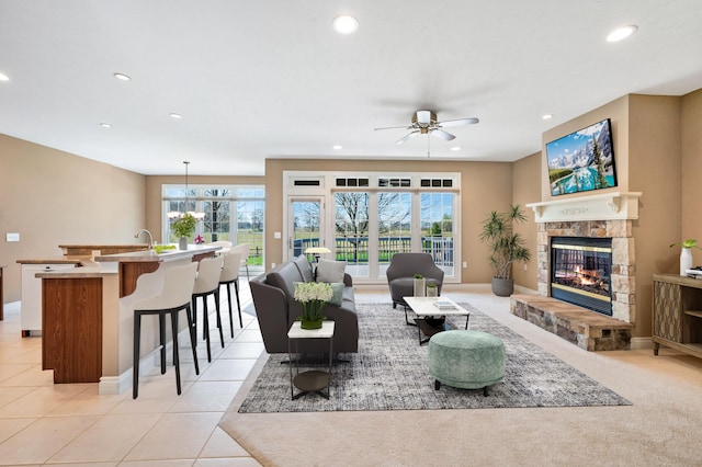 living area featuring recessed lighting, a ceiling fan, a wealth of natural light, and a fireplace