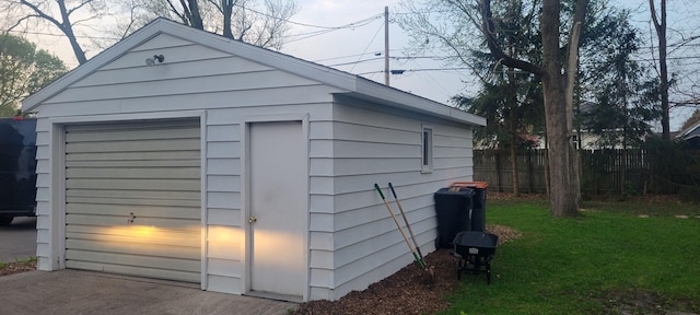 view of outbuilding featuring fence and an outbuilding