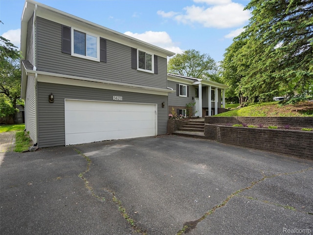 5620 Eastman Blvd, West Bloomfield, MI 48323 - view of front of home featuring a garage and driveway