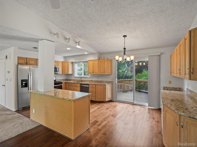 5620 Eastman Blvd, West Bloomfield, MI 48323 - kitchen featuring appliances with stainless steel finishes, a textured ceiling, light wood-style floors, a chandelier, and light stone counters