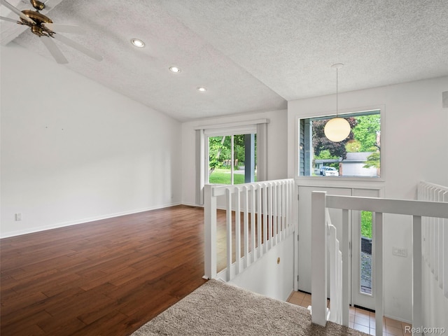 5620 Eastman Blvd, West Bloomfield, MI 48323 - corridor featuring an upstairs landing, a textured ceiling, healthy amount of natural light, recessed lighting, and wood finished floors