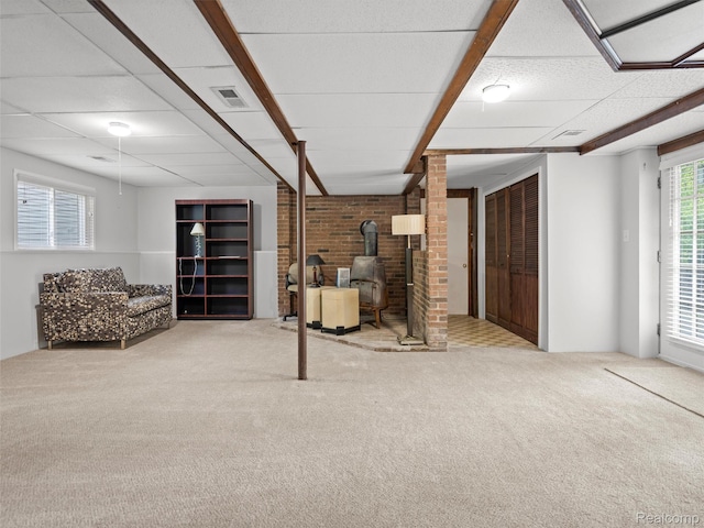 5620 Eastman Blvd, West Bloomfield, MI 48323 - basement featuring carpet flooring, a wood stove, and brick wall