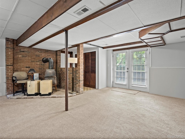5620 Eastman Blvd, West Bloomfield, MI 48323 - below grade area featuring a wood stove, carpet flooring, french doors, and brick wall