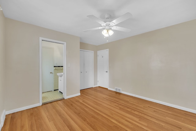 27610 Denmar Dr, Warren, MI 48093 - unfurnished bedroom with visible vents, baseboards, a ceiling fan, light wood-style flooring, and ensuite bath