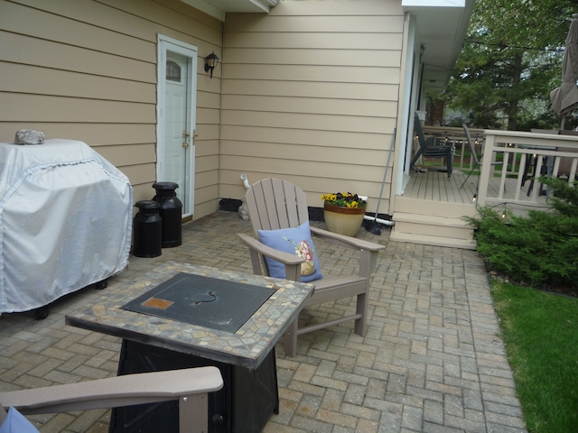 view of patio / terrace with a wooden deck and a grill