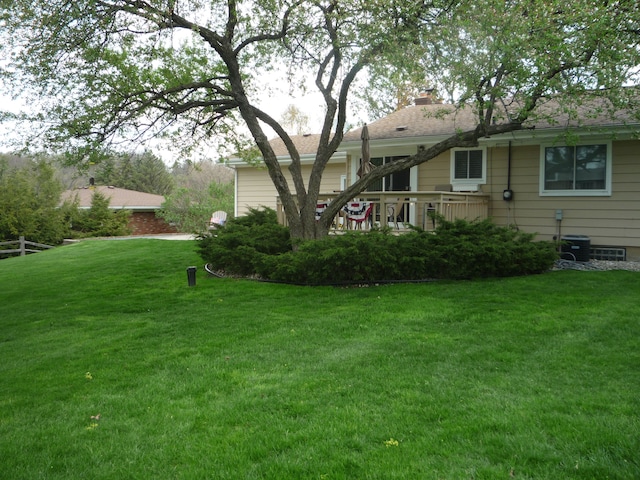 rear view of property with a lawn and a chimney