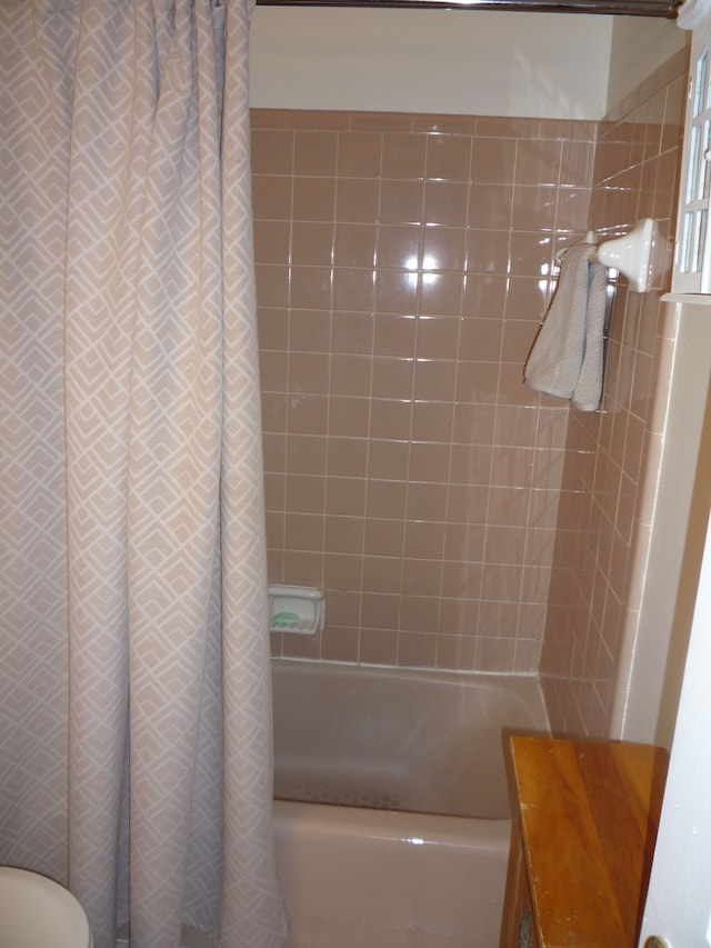 full bath featuring shower / tub combo with curtain