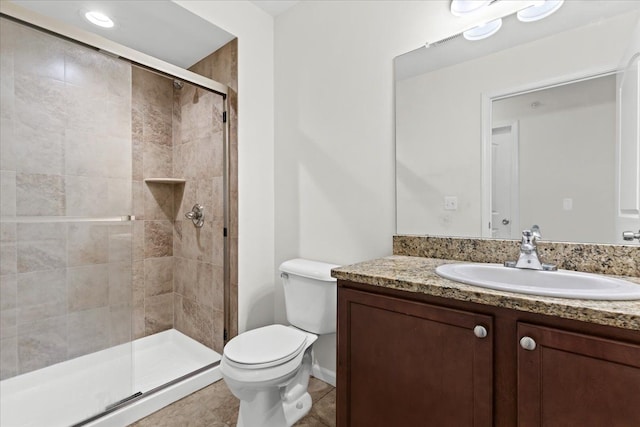 full bathroom featuring vanity, toilet, tile patterned floors, and a stall shower