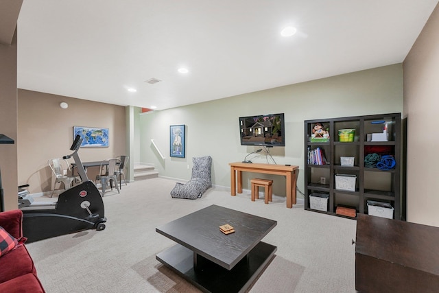 carpeted living area with recessed lighting, stairs, and visible vents