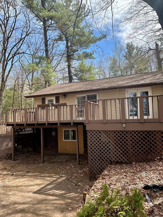757 E Sidney Rd, Stanton, MI 48888 - rear view of house featuring a shingled roof and a deck
