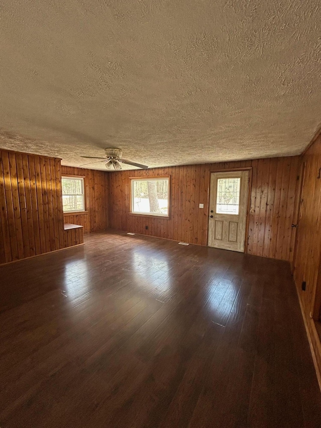 757 E Sidney Rd, Stanton, MI 48888 - spare room featuring wood-type flooring, a textured ceiling, ceiling fan, and a healthy amount of sunlight