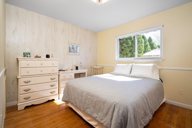 bedroom featuring baseboards and wood finished floors