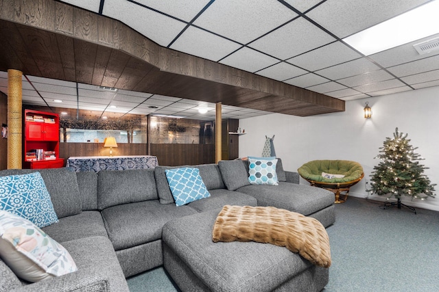 living area featuring carpet flooring, baseboards, visible vents, and a drop ceiling