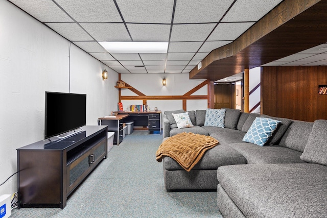living area with stairway, carpet, and a drop ceiling