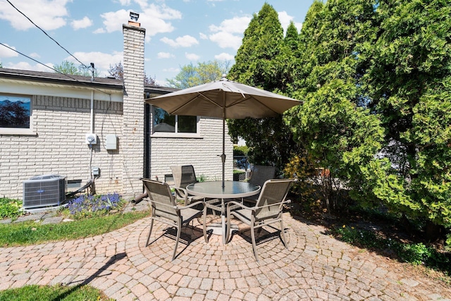 view of patio featuring cooling unit and outdoor dining space