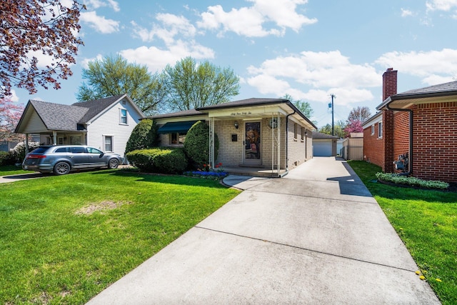 ranch-style house featuring a garage, an outdoor structure, a front lawn, and brick siding