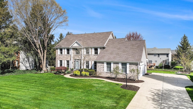 view of front of home featuring a chimney, a front yard, a garage, concrete driveway, and a shingled roof