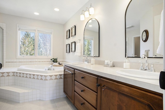 full bath featuring tile patterned flooring, a sink, and a wealth of natural light