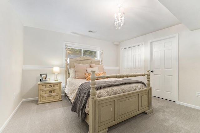bedroom with a closet, visible vents, light carpet, baseboards, and a chandelier