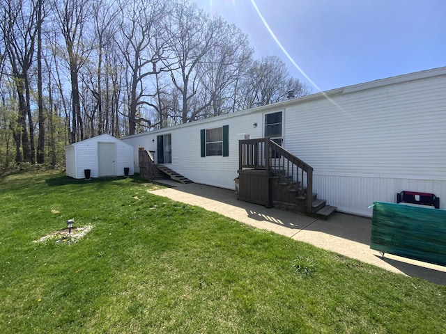 back of house with a storage unit, an outdoor structure, a lawn, and a patio