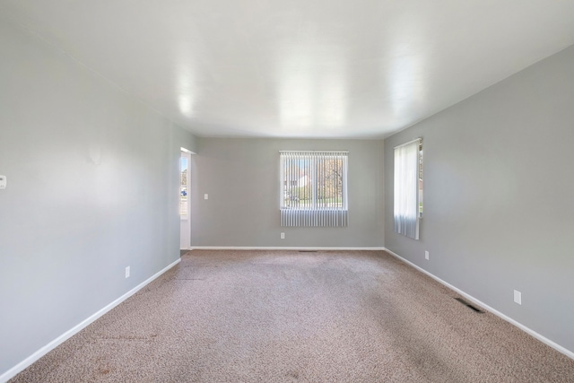 empty room with carpet floors and baseboards