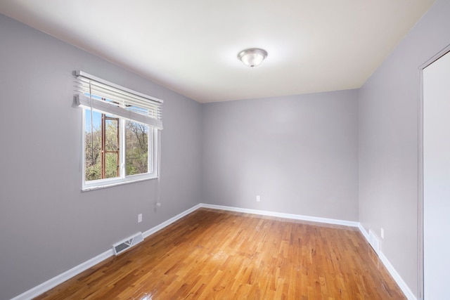 unfurnished room with visible vents, baseboards, and light wood-type flooring