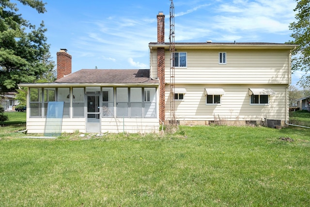 rear view of property featuring a lawn, a chimney, a sunroom, and central AC