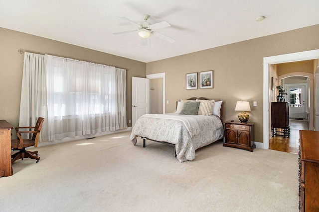 8 Georgia Ct, Pentwater, MI 49449 - carpeted bedroom featuring arched walkways, ceiling fan, and visible vents