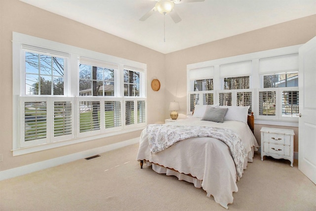 8 Georgia Ct, Pentwater, MI 49449 - bedroom with visible vents, carpet flooring, baseboards, and a ceiling fan