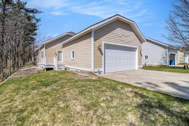 8 Georgia Ct, Pentwater, MI 49449 - view of side of home with concrete driveway, a yard, and a garage