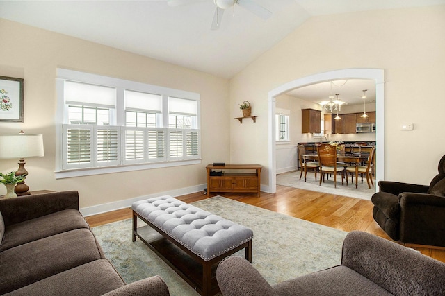8 Georgia Ct, Pentwater, MI 49449 - living area featuring ceiling fan, arched walkways, baseboards, lofted ceiling, and light wood-type flooring