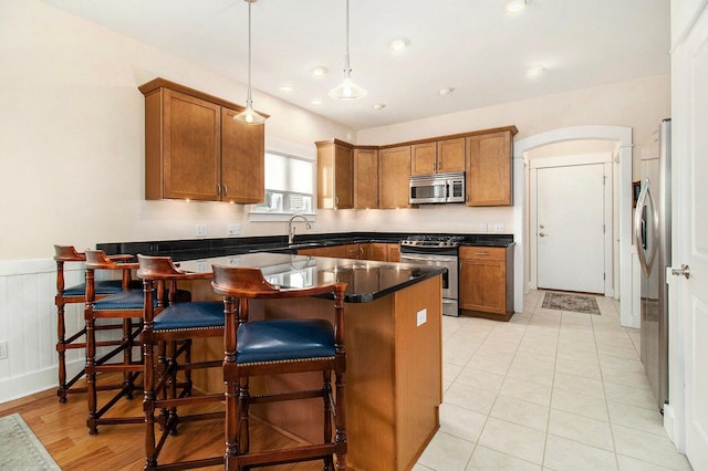 8 Georgia Ct, Pentwater, MI 49449 - kitchen with brown cabinets, stainless steel appliances, dark countertops, and a peninsula