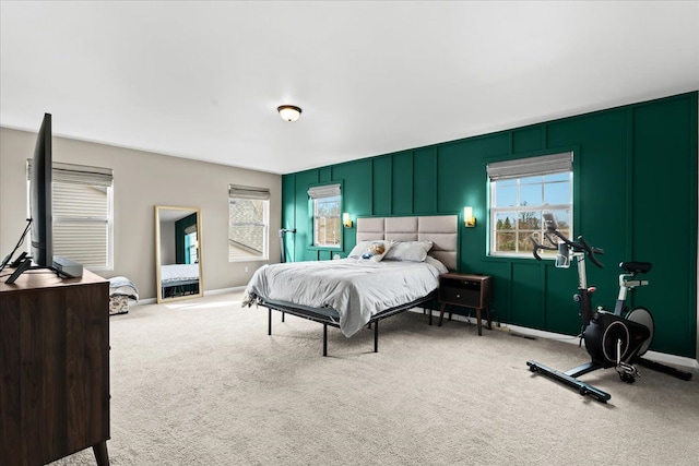 bedroom with carpet floors, baseboards, visible vents, and multiple windows
