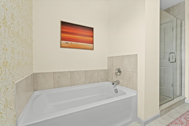 bathroom featuring tile patterned flooring, a bath, a stall shower, and wallpapered walls