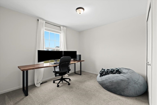 carpeted office space with baseboards