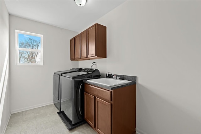 laundry room with washer and dryer, baseboards, a sink, and cabinet space
