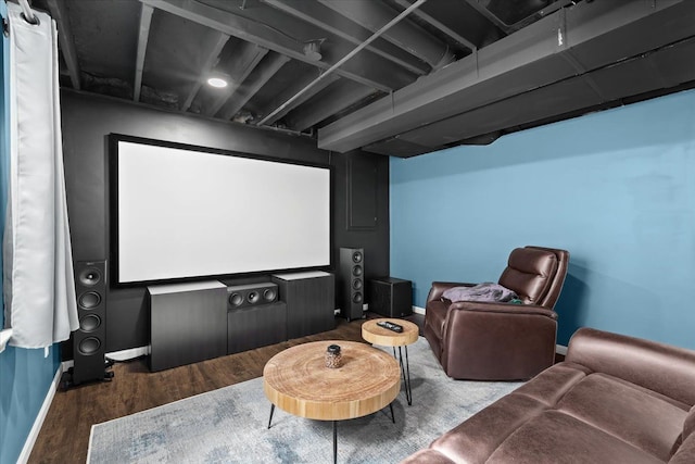 cinema room with baseboards and wood finished floors