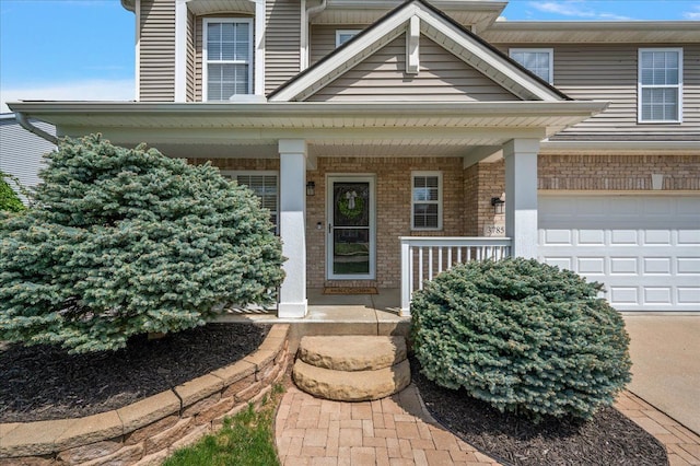 doorway to property with covered porch and brick siding